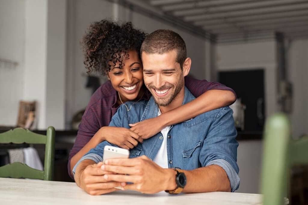 couple planning wedding using smartphone