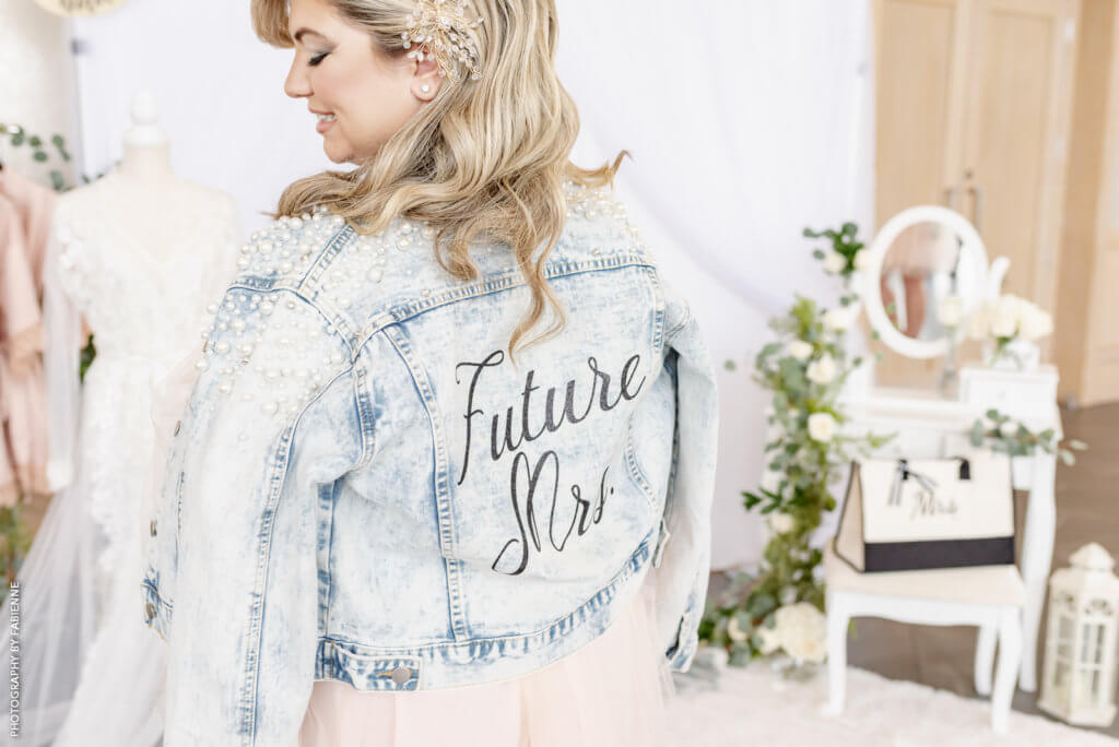 Bride wearing a "Future Mrs." denim jacket.