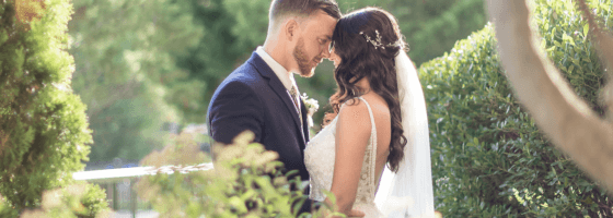 bride and groom posed in the scenic fall-decorated outdoor patio