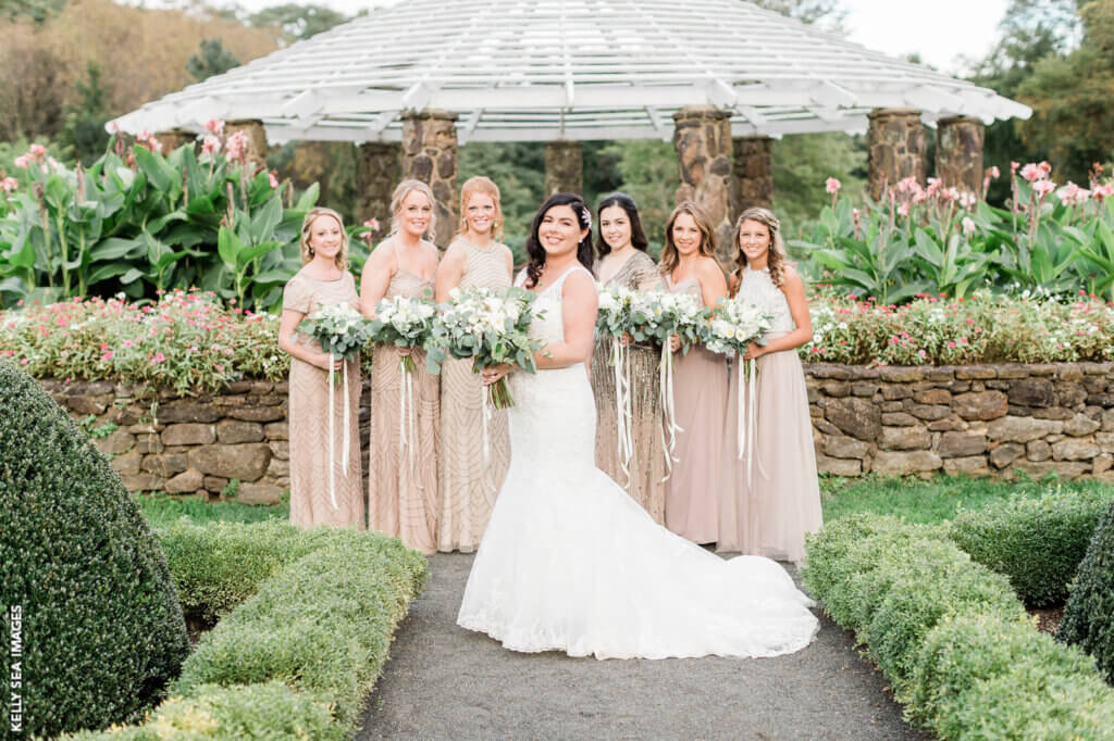 bride and bridesmaids posted in a garden